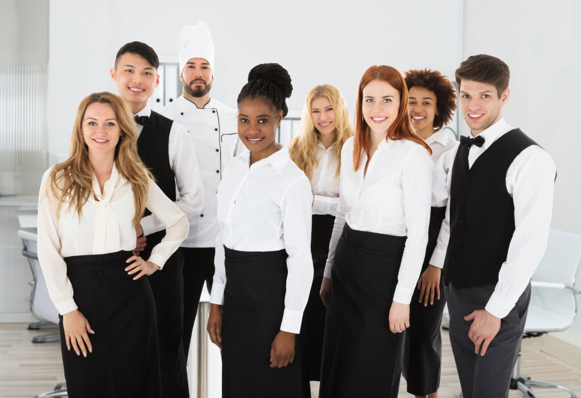 a diverse group of restaurant staff standing together in a bright, modern setting