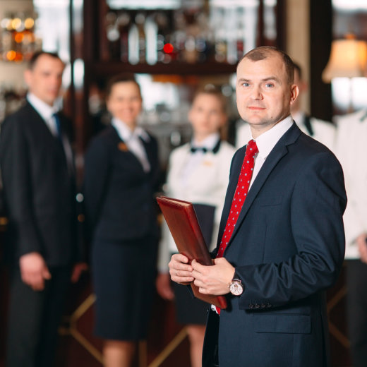 Hotel or restaurant manager and his staff in kitchen